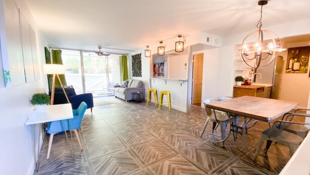 A modern kitchen with a dining area, a sofa, and a small table with chairs. - Cozy 1-bedroom, resort style condo. w/ WiFi, AC in beautiful Scottsdale (Scottsdale)