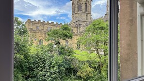 A historic building with a prominent tower, surrounded by lush greenery. - 3 bedroom accommodation in Bakewell (Bakewell)