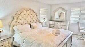 A bedroom with a large bed, a dresser, a chair, and a mirror. - Cozy, Quiet, Bothell River House (Bothell)