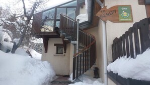 A staircase leading to a building with a wooden handrail and a sign reading "Le GENDEP".
