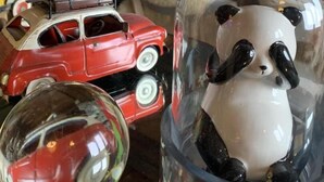 A room with a wooden cabinet, a glass dome with a panda figurine, a red toy car, and a glass sphere. - DU PRAZ - LA GRANDE OURSE (SAINTE FOY TARENTAISE)