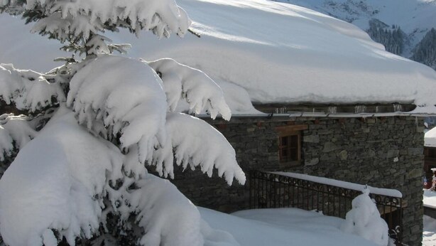 A snow-covered mountain landscape with a stone building and a snow-covered tree in the foreground. - DU PRAZ - LA GRANDE OURSE (SAINTE FOY TARENTAISE)