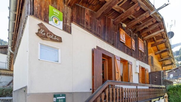 A traditional wooden building with a sign reading 'Le Colibri' and a green sign above it. - LE COLIBRI - BEAUFORT ARECHES (BEAUFORT ARECHES)