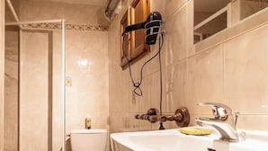 A bathroom with a toilet, a sink, and a shower enclosure. - LE COLIBRI - BEAUFORT ARECHES (BEAUFORT ARECHES)