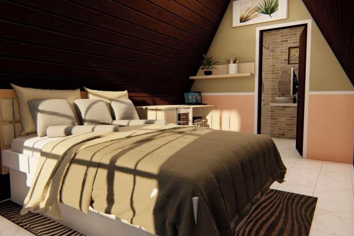 Ein Schlafzimmer mit einem Bett, einem Nachttisch und einem kleinen Schreibtisch mit Stuhl. Eine Tür führt zu einem Badezimmer.