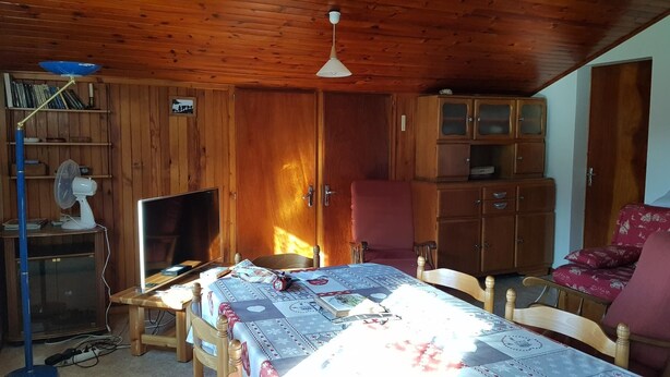 A cozy room with a wooden ceiling, a bed with a patterned bedspread, a desk with a computer, a chair, and a cabinet with glass doors. - LE CHAR - LA GIETTAZ (LA GIETTAZ)