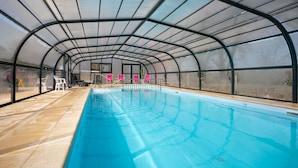 An indoor swimming pool with a glass ceiling, clear water, and a tiled floor. - Stereden Cottage Village - Chalet 2 - with Private Terrace and Shared Garden (Pleumeur-Bodou)
