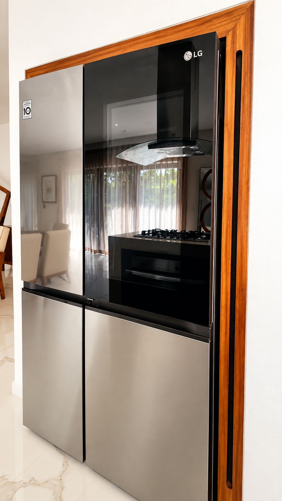A modern kitchen with a stainless steel refrigerator, a built-in oven, and a gas stove.