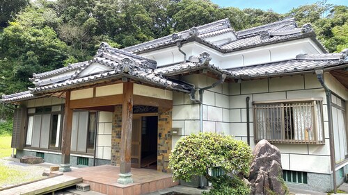 A whole old minka house in a natural setting with an open-air bath