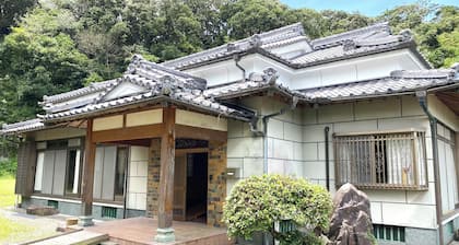 A whole old minka house in a natural setting with an open-air bath