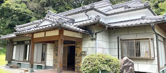 A whole old minka house in a natural setting with an open-air bath