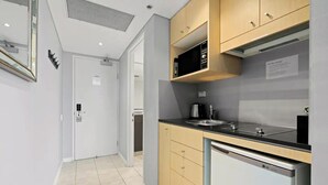 A modern kitchen with a dishwasher, a stove, and a sink. - KozyGuru | Haymarket | Chic City Studio (Haymarket)