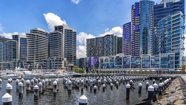 A marina with boats docked, surrounded by modern high-rise buildings. - KozyGuru | Abbotsford | Cosy 1Bed Apt (Abbotsford)
