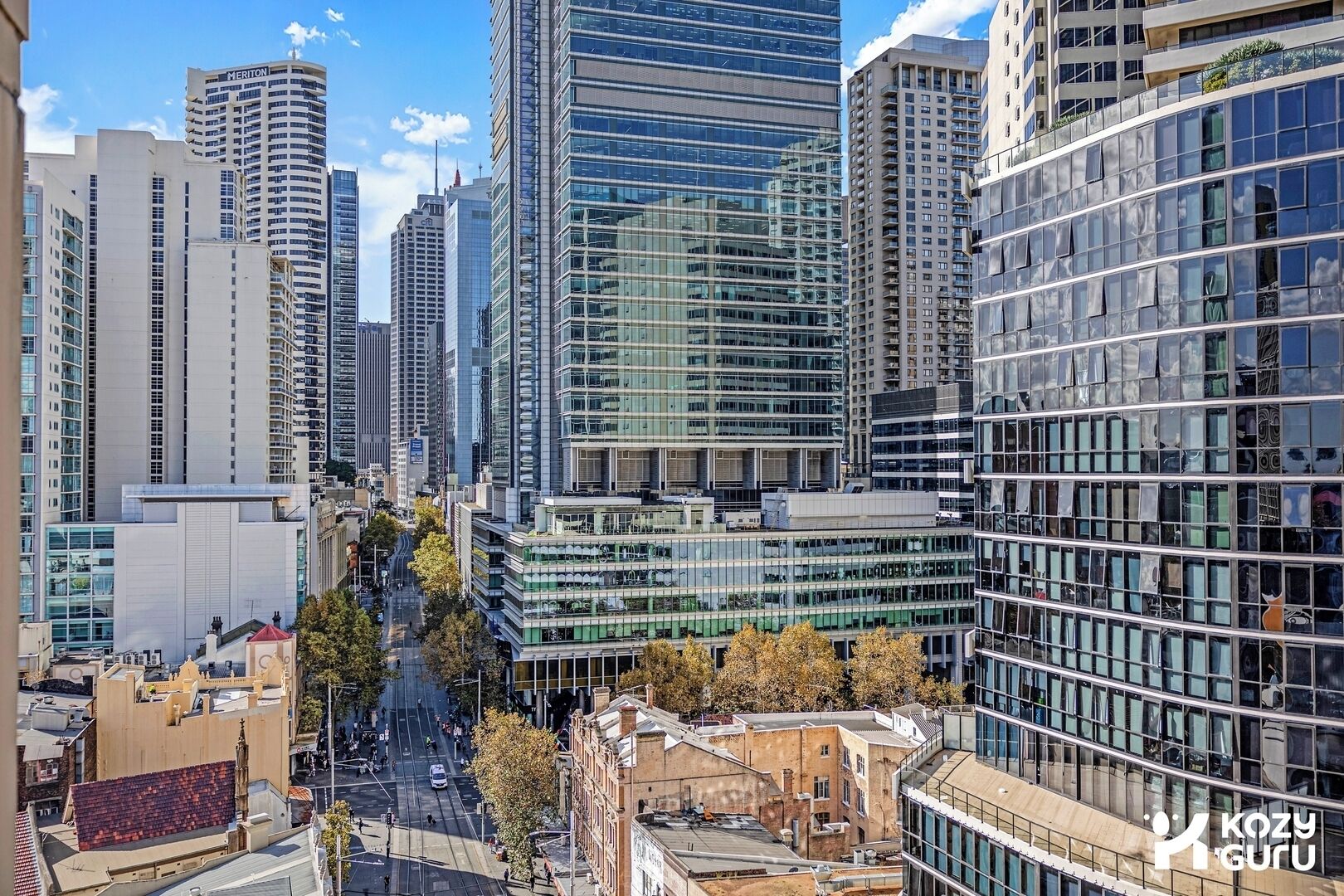 A cityscape with high-rise buildings, including a hotel with a prominent sign.