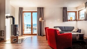 Een moderne woonkamer met een bank, een tafel en een open haard.