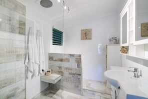 Shower, hair dryer, soap, toilet paper