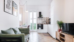 A modern apartment with a living room, kitchen, and dining area. - Easylife - Apartment with balcony near Navigli (Milano)