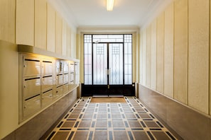 Guests can access secure storage lockers and an entrance through this symmetrical corridor.