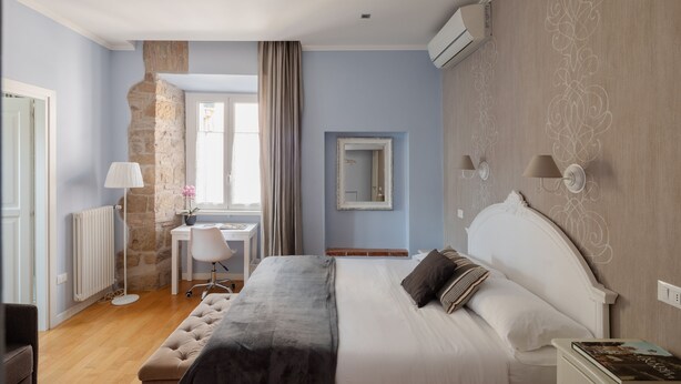 Un dormitorio con cama, escritorio y silla.