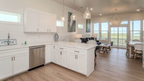 A modern kitchen with white cabinetry, a dishwasher, and pendant lighting. - 3 Quarterdeck Lane (Fripp Island)