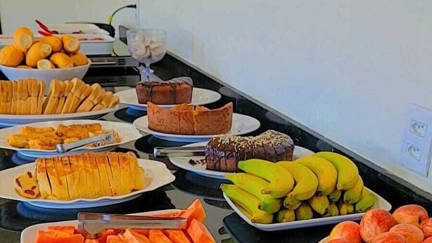 Ein Buffet mit verschiedenen Speisen, darunter Obst, Gemüse und Desserts.