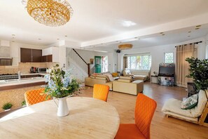 A modern living space with a kitchen, dining area, and seating area.