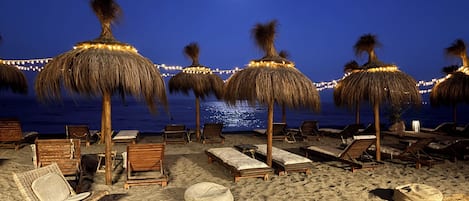On the beach, sun loungers, beach towels