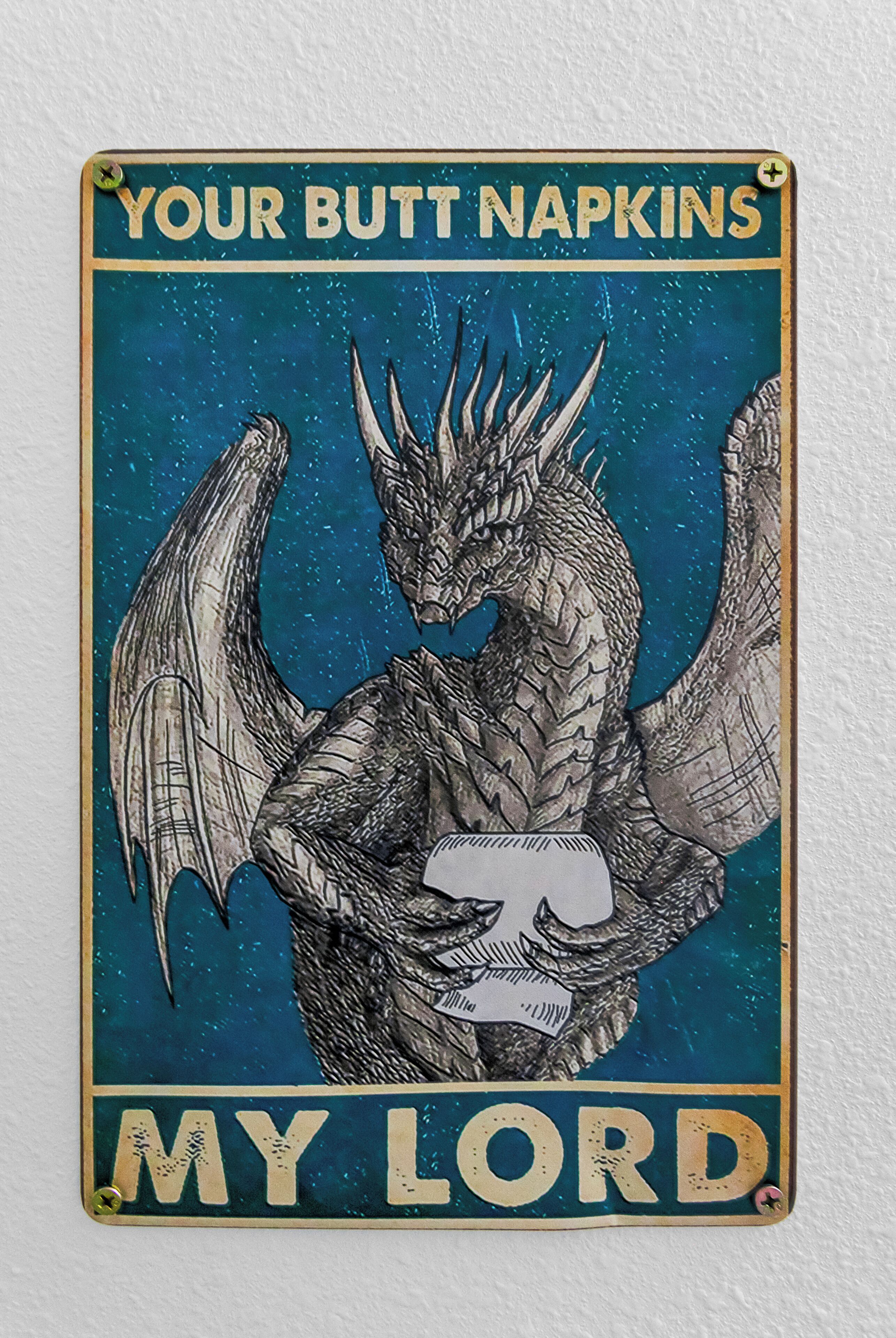 A vintage sign with a dragon illustration and the text "YOUR BUTT NAPKINS MY LORD".