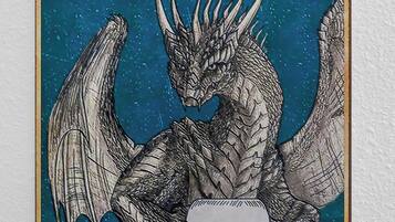 A vintage sign with a dragon illustration and the text "YOUR BUTT NAPKINS MY LORD".