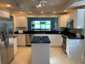 Fridge, microwave, oven, stovetop - Windstar on Naples Bay 2 bedroom + den condo with water and golf course view. (Naples)