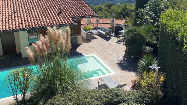 A house with a tiled roof, a swimming pool, and a patio area with outdoor furniture. - Soothing villa with with private pool, seasonally heated; pet friendly (Villanuova sul Clisi)