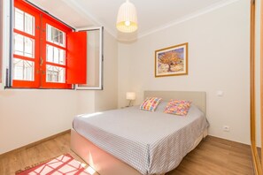 Cozy retreat with a large bed, bedside table, and a beautiful view.
