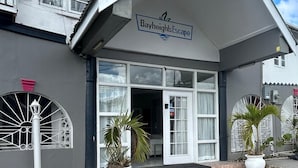 A building with a sign reading "BayheightsEscape" at the entrance. - Poolside Suites 5-Mins from the Beach w/ AC & Wi-Fi (Rodney Bay)