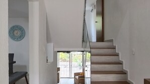 A modern interior with a staircase leading to an upper level. - Casa Comfy (Cancun)