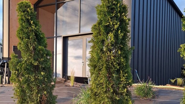 A modern building with a sloped roof and large glass windows. - Modern chalet - relaxing stay with private spa, calm, nature and comfort (RUYNES EN MARGERIDE)