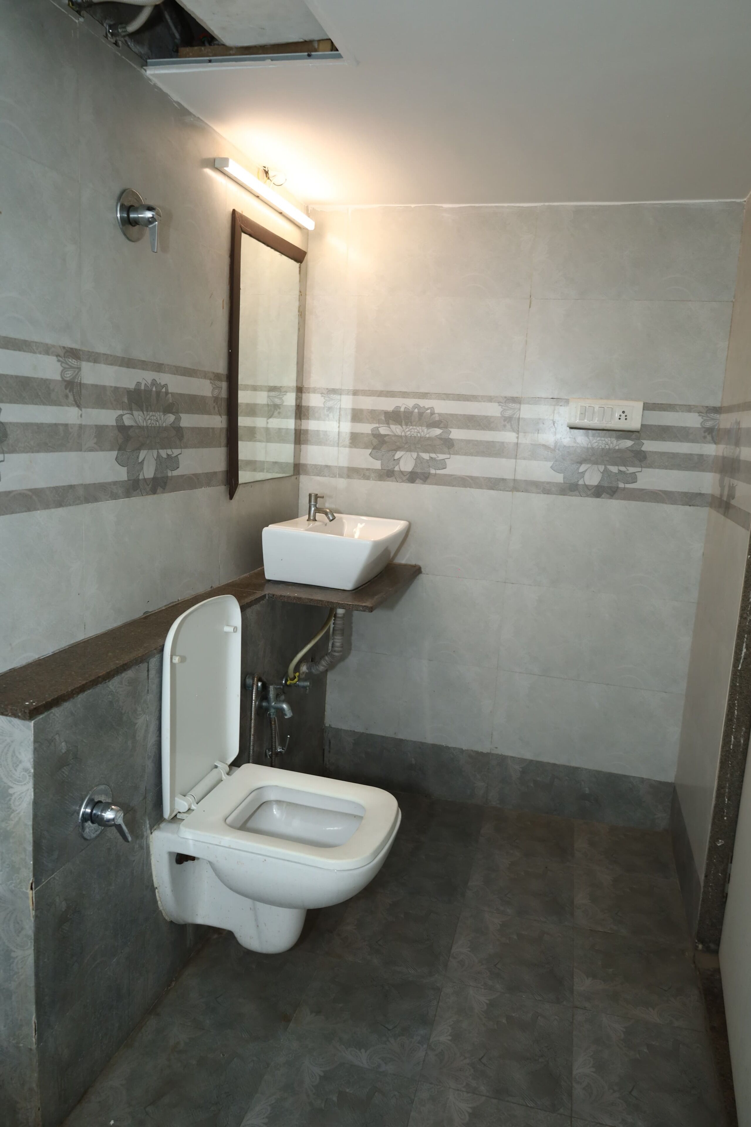 A bathroom with a toilet, sink, and shower.
