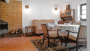 A cozy living room with a fireplace, wooden furniture, and a dining area. - Amazing apartment in Huta Gorna with WiFi (Huta Gorna)