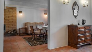 A cozy room with a wooden wall, a sofa, a dining table, and a cabinet. - Amazing apartment in Huta Gorna with WiFi (Huta Gorna)