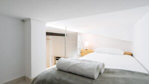 Quarto moderno e minimalista com cama, mesa de cabeceira e closet espaçoso.