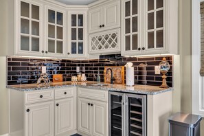 A kitchen with white cabinetry, a tiled backsplash, and a built-in refrigerator. - Professionally Managed | Walk to Beach (Seaside Heights)