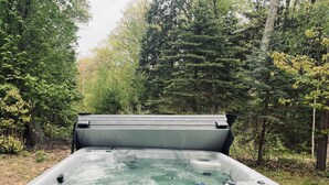 A Nordic Hot Tubs hot tub in a forested area. - HOT TUB, beach access, 2-bdrm cottage just outside Port Austin with AC & WiFi #1 (Port Austin)