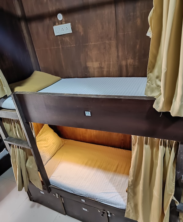 A bunk bed with a mattress and a pillow.