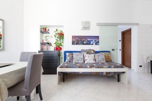 A bedroom with a bed, a desk, and a chair.