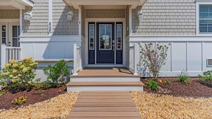 A residential house with a front porch, a double door, and a small garden area with gravel and plants. - Professionally Managed | 1 Block to Beach (Seaside Park)