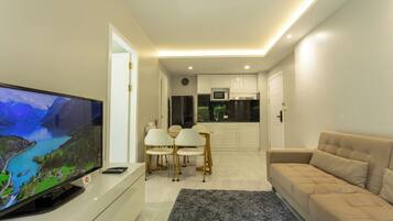 Basic Condo, Pool View | Living area | Flat-screen TV