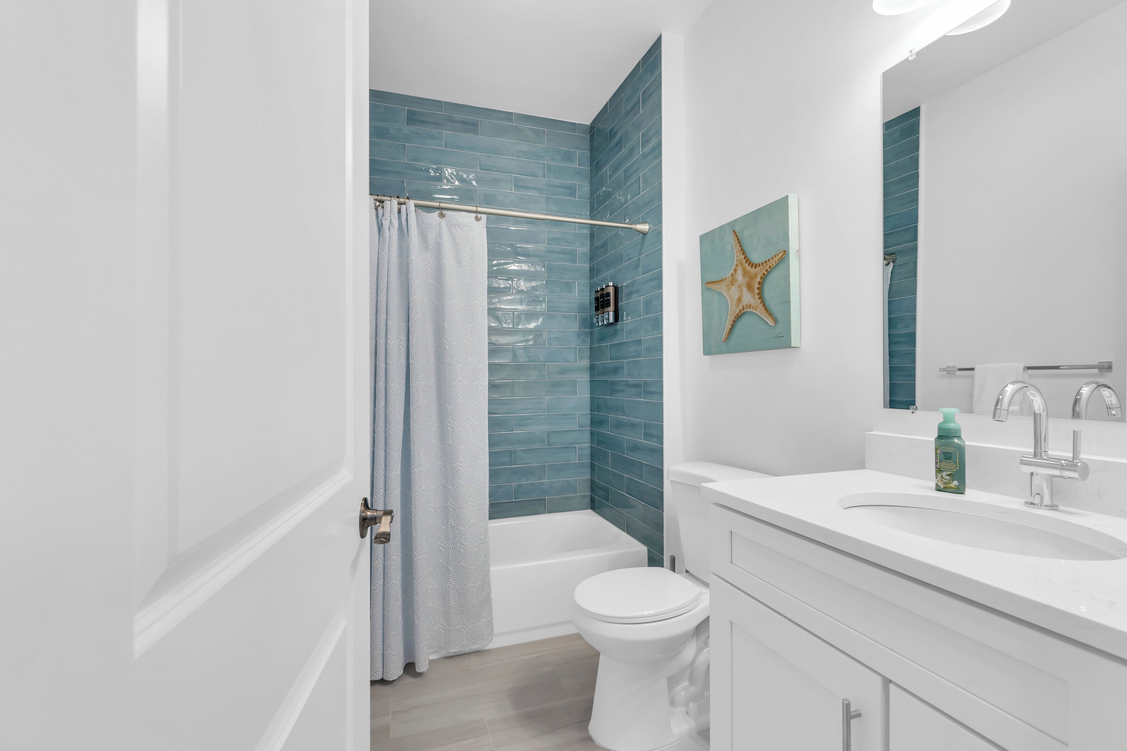 A bathroom with a bathtub, toilet, and sink.
