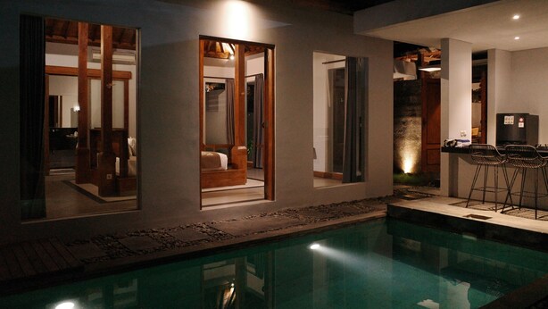 A modern house with a swimming pool, large windows, and a bar area. - The Riang Villa (Kerobokan)