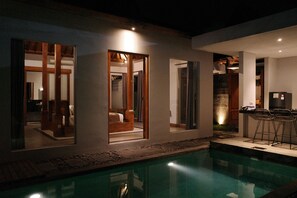 A modern house with a swimming pool, large windows, and a bar area. - The Riang Villa (Kerobokan)