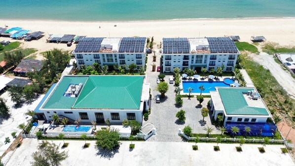 A resort with multiple buildings, a swimming pool, and solar panels. - Hoang Yen Boutique Hotel (Da Nang)