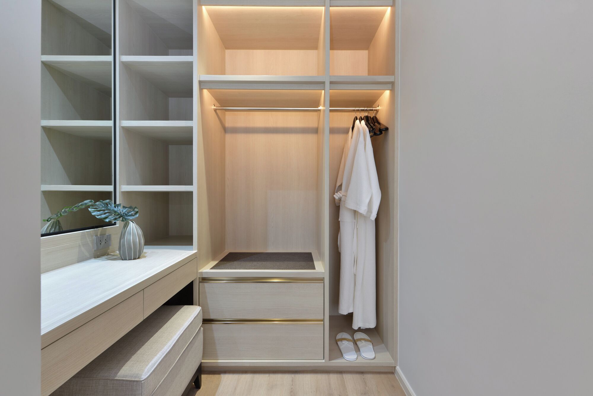 A walk-in closet with open shelving, a hanging rod, and a shoe rack.